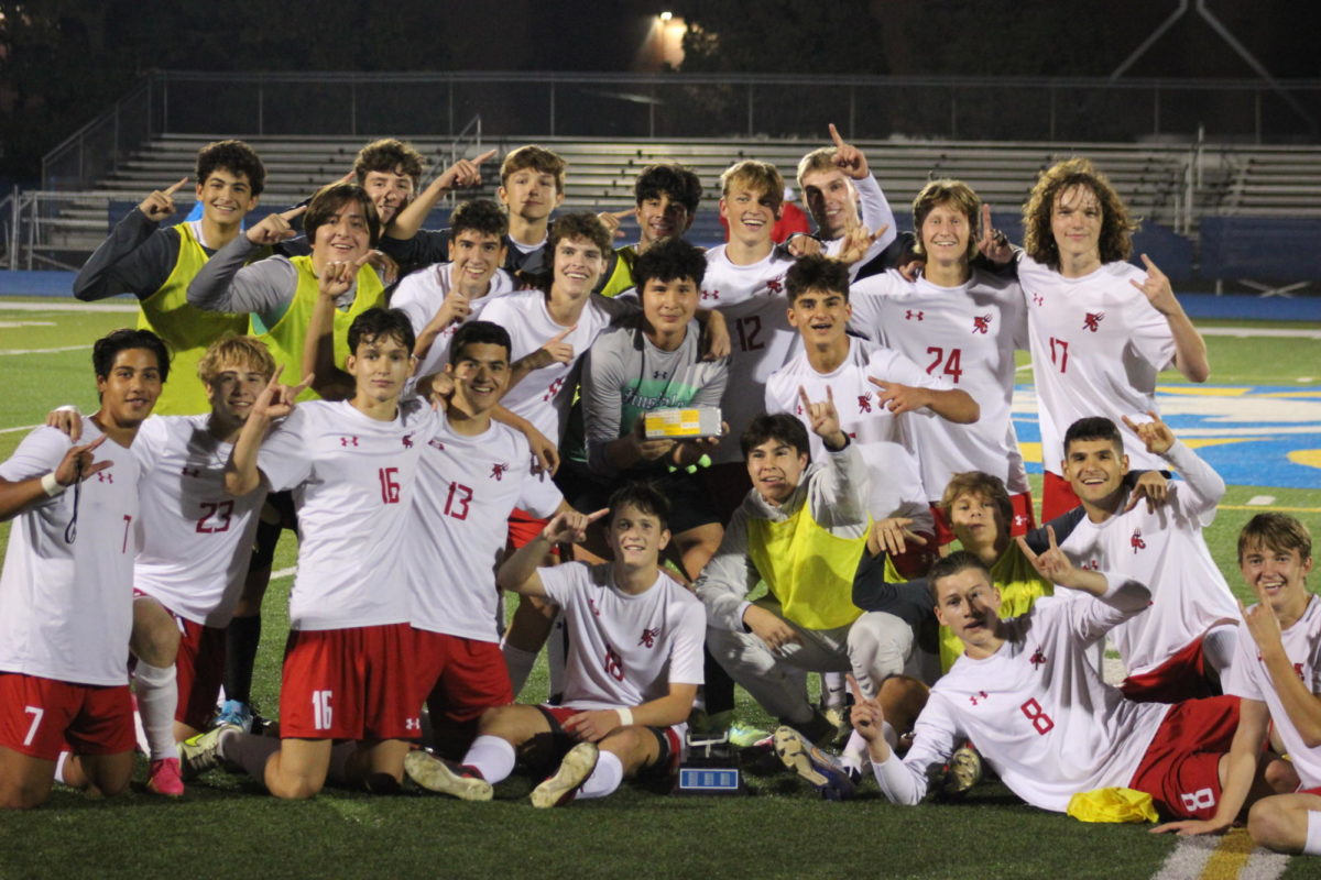 Boys soccer pose with the Silver Brick trophy, earned after beating LT on Wednesday night.