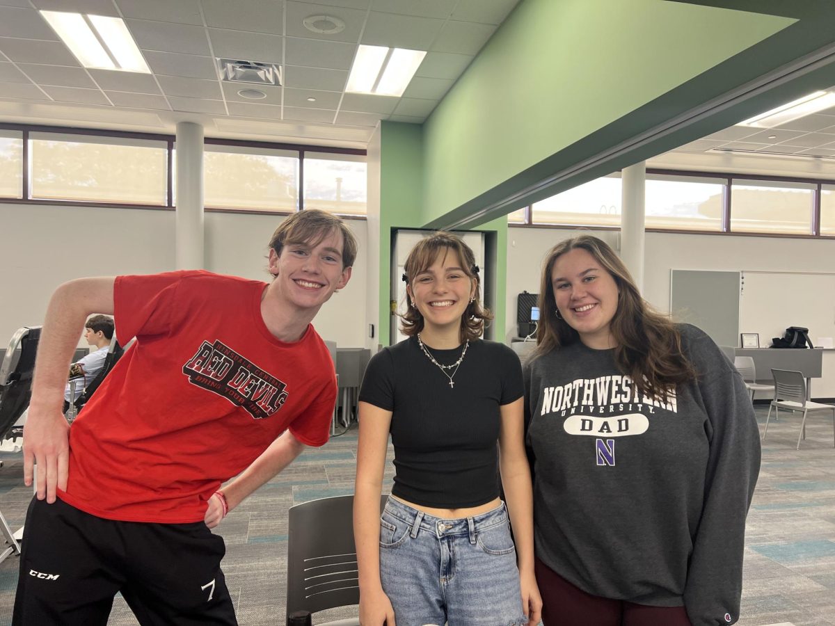 (Left to right) Thomas DeBruin, senior, Ella Graeb, senior, and Naomi Cook, senior, assist those running the blood drive by providing snacks for those who donated.