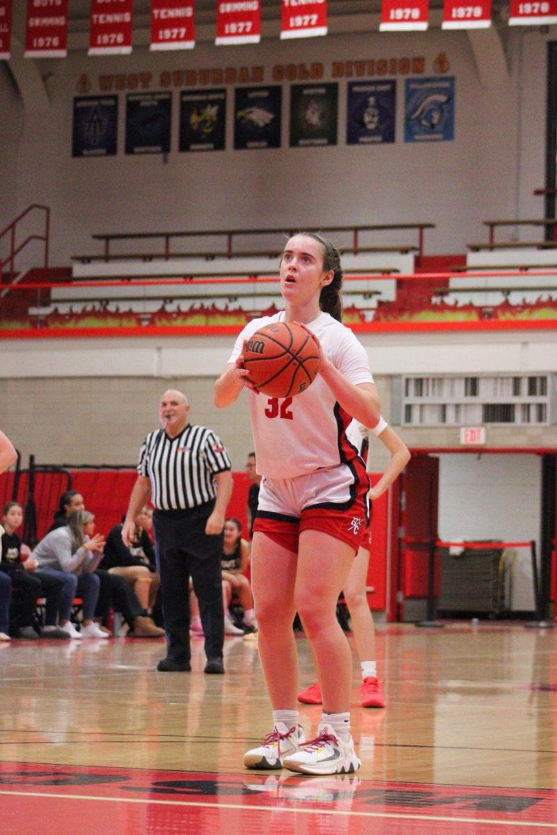 Grace Dolan, junior and varsity player, makes a basket during the game. 