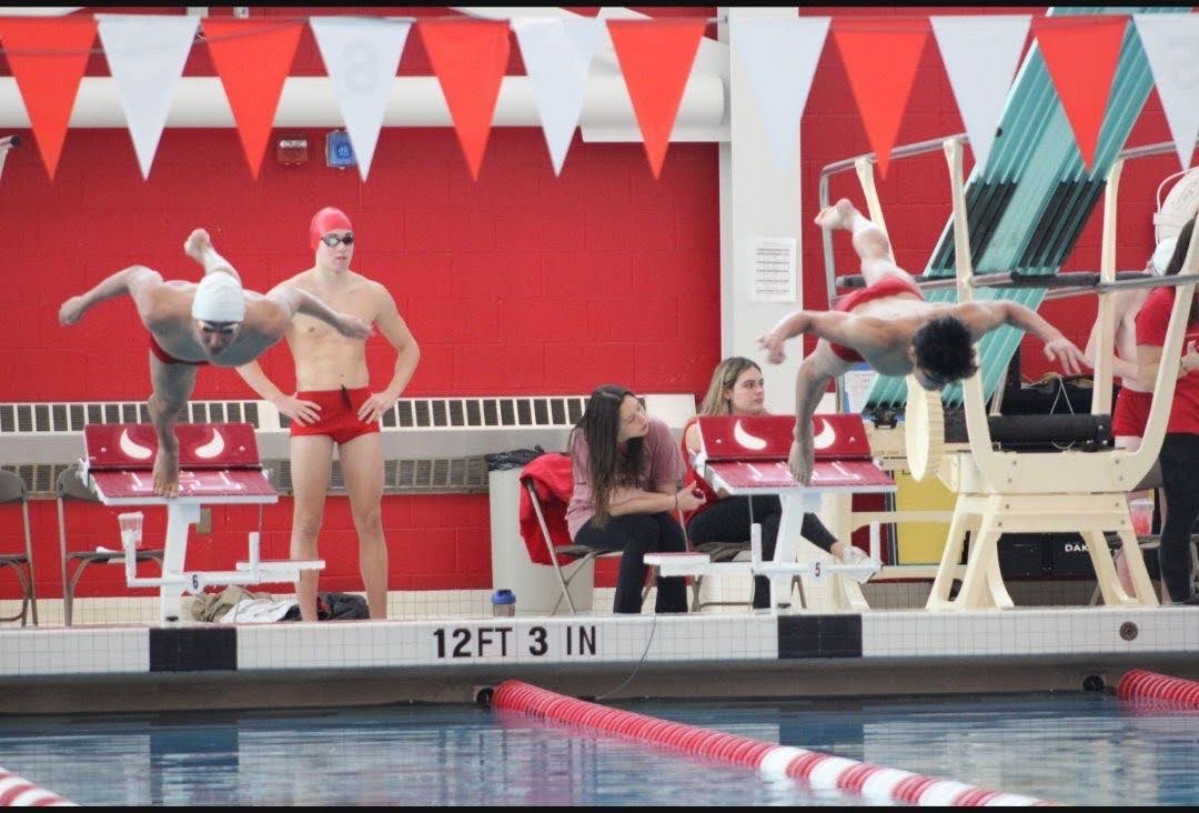 To+start+the+Hinsdale+Central%E2%80%99s+Swim+and+Dive+season%2C+Matthew+Vatev%2C+sophomore+%28left%29%2C+and+Jeffrey+Hou%2C+senior+%28right%29%2C+dive+into+the+pool+during+the+Red+vs.+White+intersquad+meet+on+Nov.+25.+The+intersquad+meet+was+the+last+part+of+the+tryout+process+where+the+swimmers+split+up+into+two+teams+and+competed+against+one+another.
