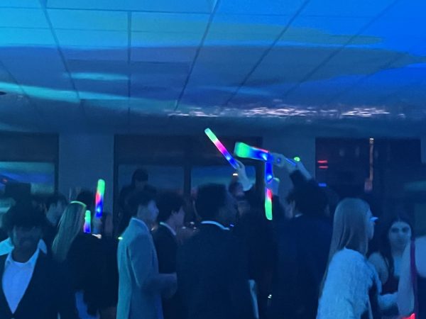 Students celebrate the night with light up glow sticks.
