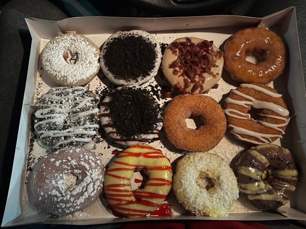 A dozen of Duck Donuts donuts served in their box.