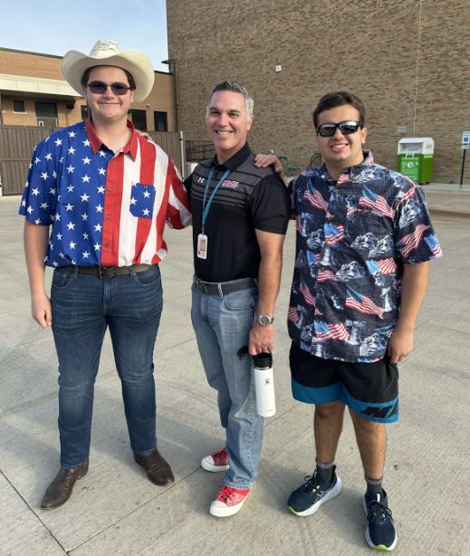 Juniors Joao Lourenco and Peitro Pamfilli pose in their American attire with Principal Walsh during the morning of May 24 as juniors celebrate the first day without seniors. 
