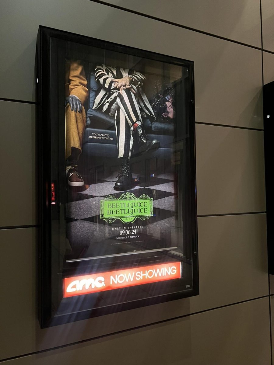 "Beetlejuice Beetlejuice" poster hung up in  an AMC theater. 