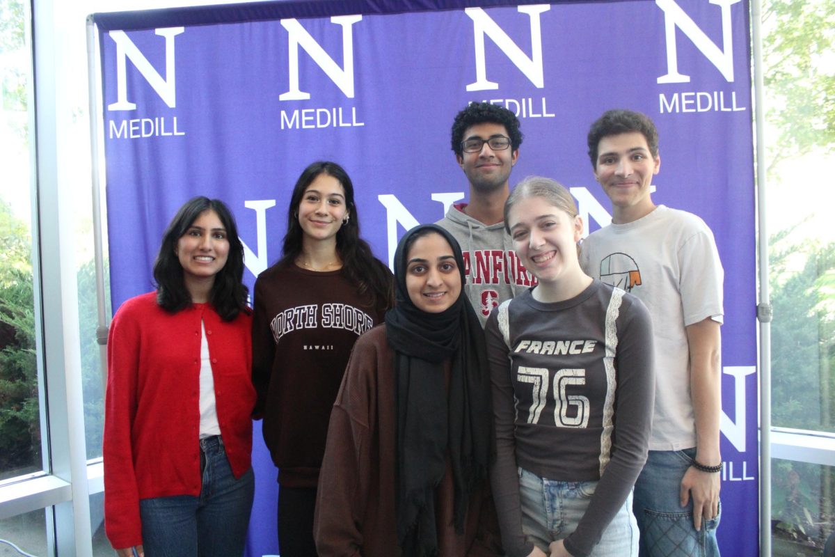 DA staff poses for a photo in front of the Medill School of Journalism backdrop.
