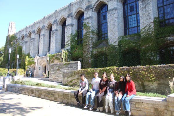 Advocate staff taking in the Northwestern campus while sitting in front of Deering Library.

