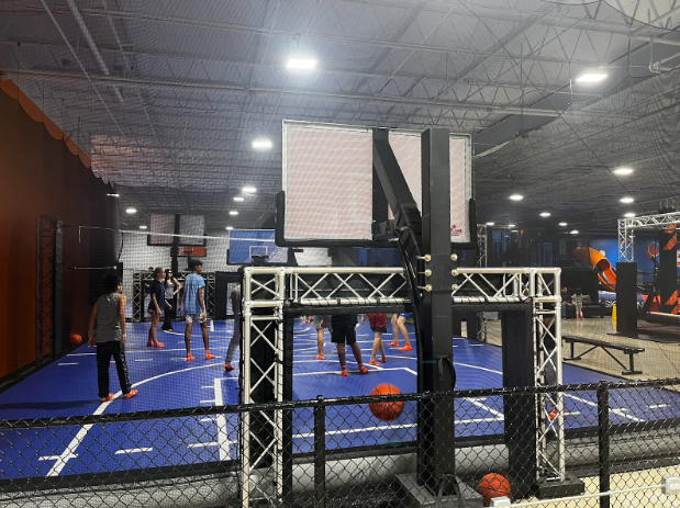 Teenagers play volleyball in the air court.