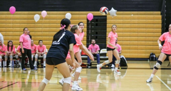 From left to right: Nora Bergin, junior, Caitlin Leddy, junior and Caitlyn Peterson, senior hitting the ball in the middle of a play.