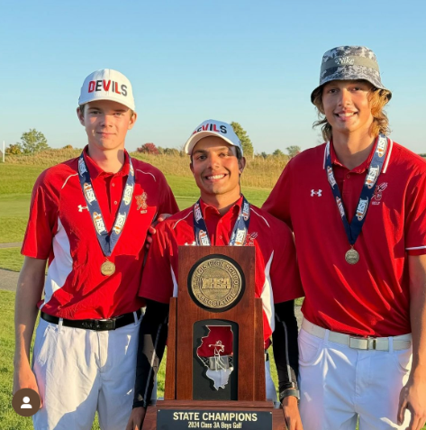 (From left to right) Seniors Isaac Schloegel, Dru Devata, and Kevin Wesolowski taking a picture with the IHSA trophy.
