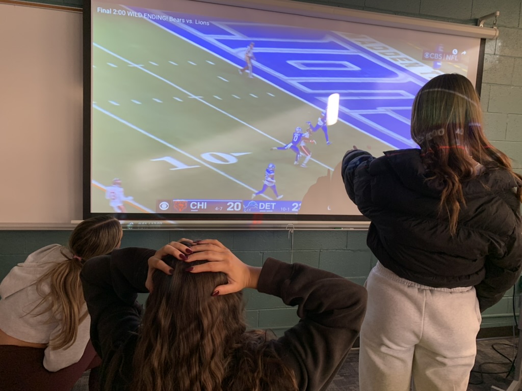 Vanessa Jovanovic, senior, Sarah Mahler, senior, and Willa Braden, junior , react to a play by the Bears.