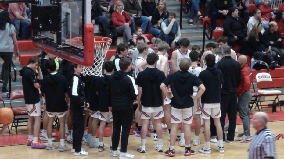 The Central team huddles before continuing the game.