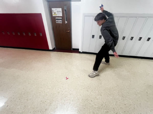 Nathan Wietecha, senior, playing ddakji, a traditional South Korean game featured in “Squid Game” Season 2.
