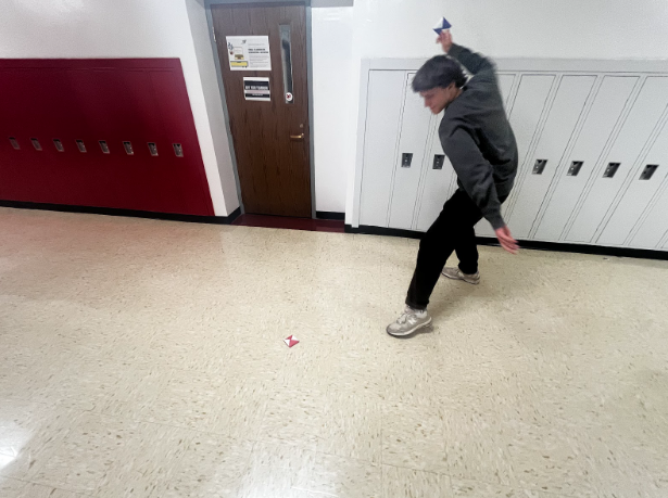 Nathan Wietecha, senior, playing ddakji, a traditional South Korean game featured in “Squid Game” Season 2.
