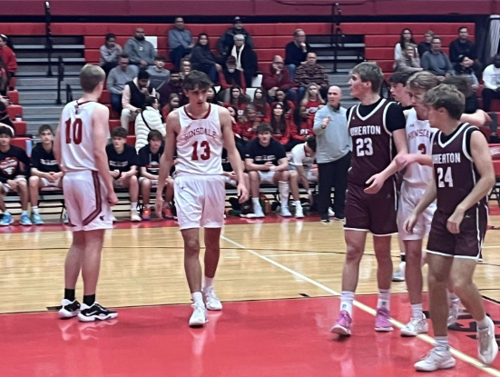 Senior Michael Howell, #13, walking after a play at the Wheaton Academy game on Jan. 17.
