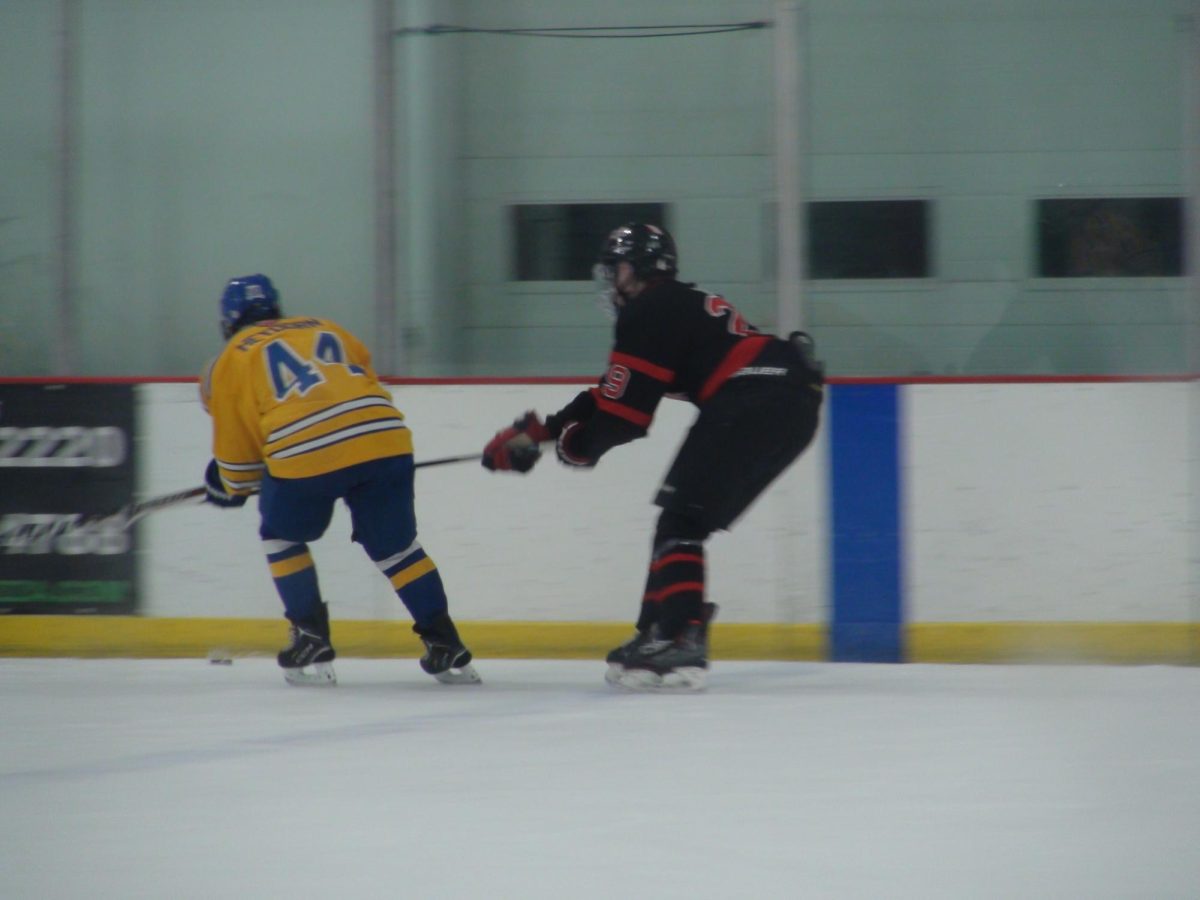 Zach Kunitz, sophomore, rushes in to maintain possession of the puck.
