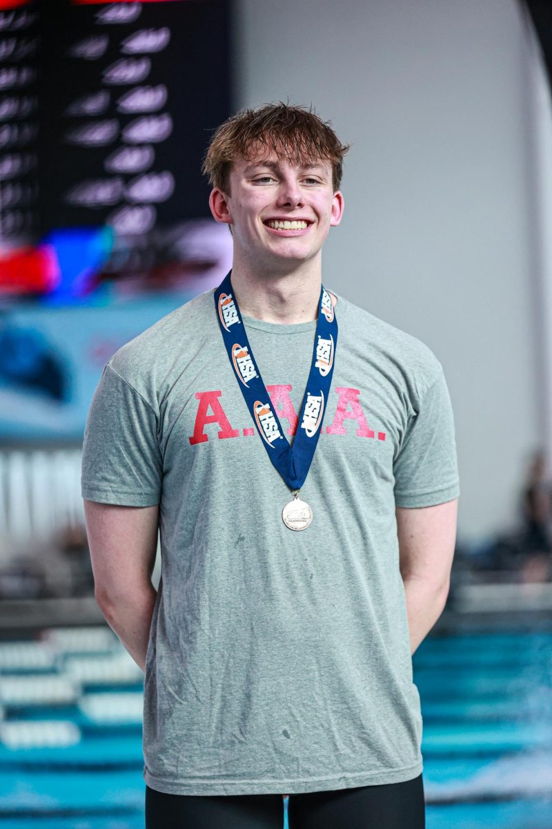 Noah Pelinkovic, senior, standing on the podium at the Boys Illinois State Championship.
