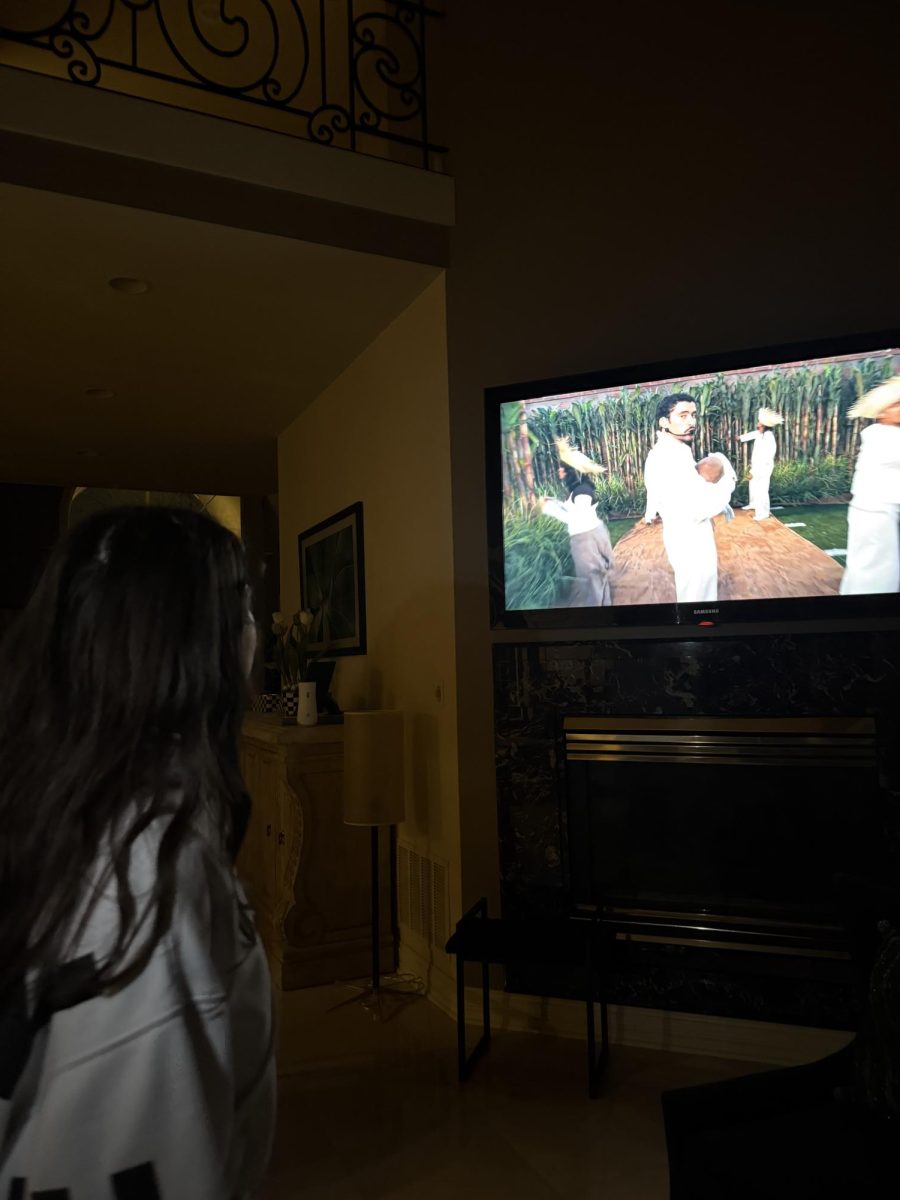 Sophomore student, Tuleen Attassi, watching Bad Bunny in the Super Bowl halftime show.