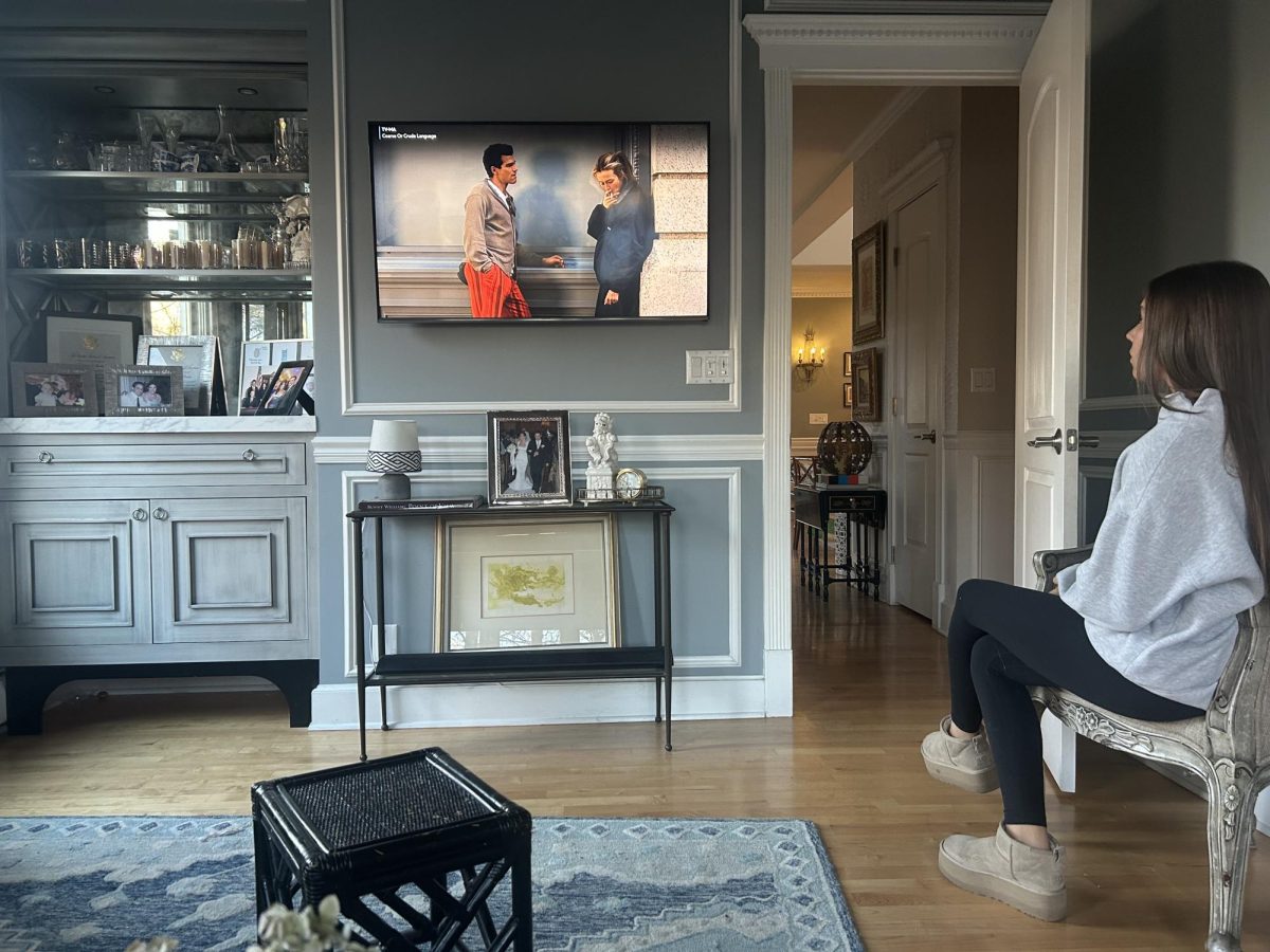 Sophomore Josie Braden watches the newest episode of "Love Story" in her living room, which depicts the relationship between John F. Kennedy Jr. and Carolyn Bassette in the 1990s. 