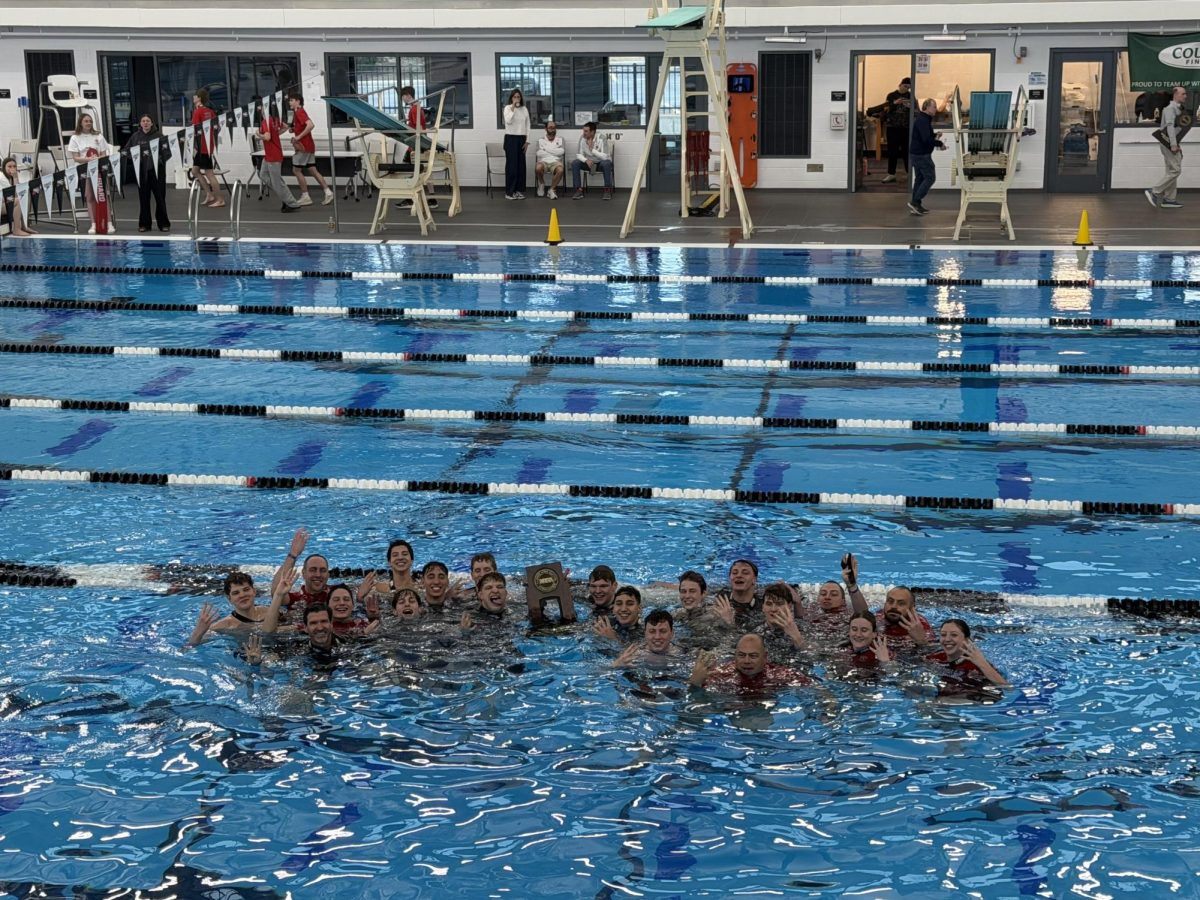Hinsdale Central Boys win state for the past four years. Hinsdale state swimmers, coaches and staff hold up the number four. 