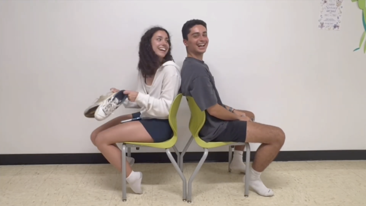 Seniors Isabella Chiaramonte and Niko Miceli answer questions for prom on April 17.